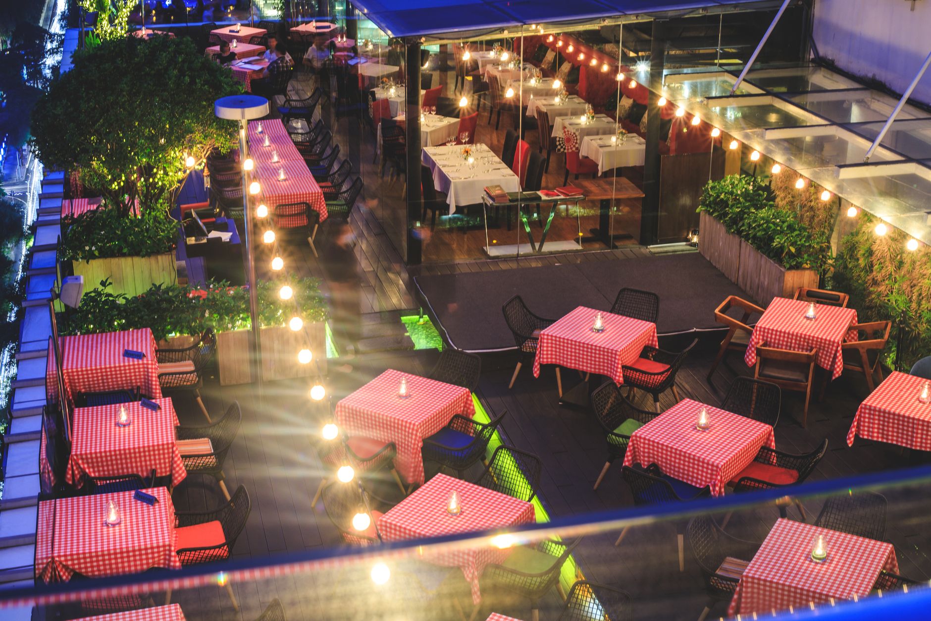 Aerial view of a colorful restaurant terrace at night
